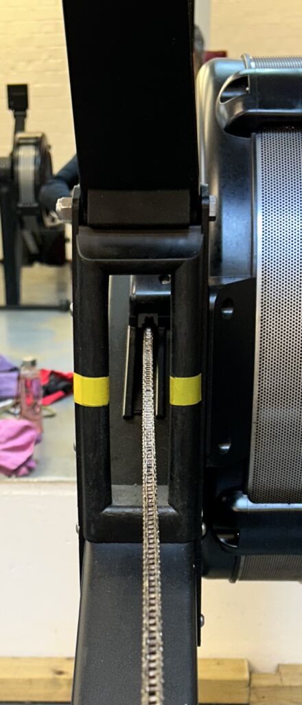 Close up shot by a PT & rower with the focus on an erg / rowing machine showing where the chain should be in the centre throughout the stroke to improve your workout 