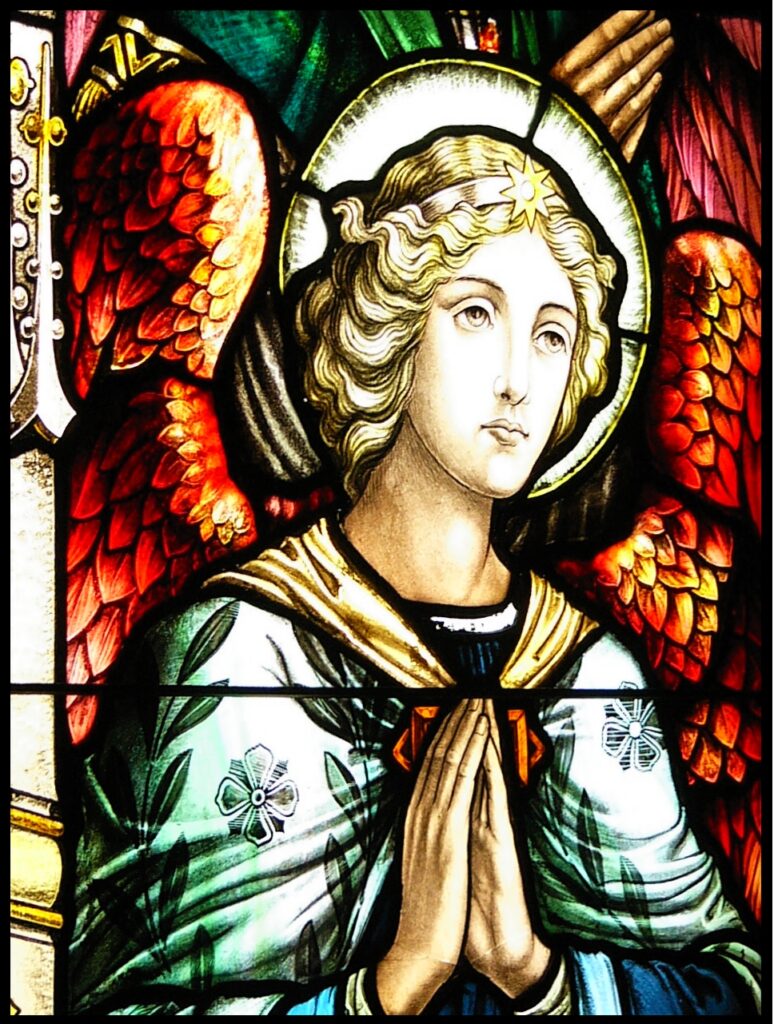 Stained glass window of angel praying to be a better person